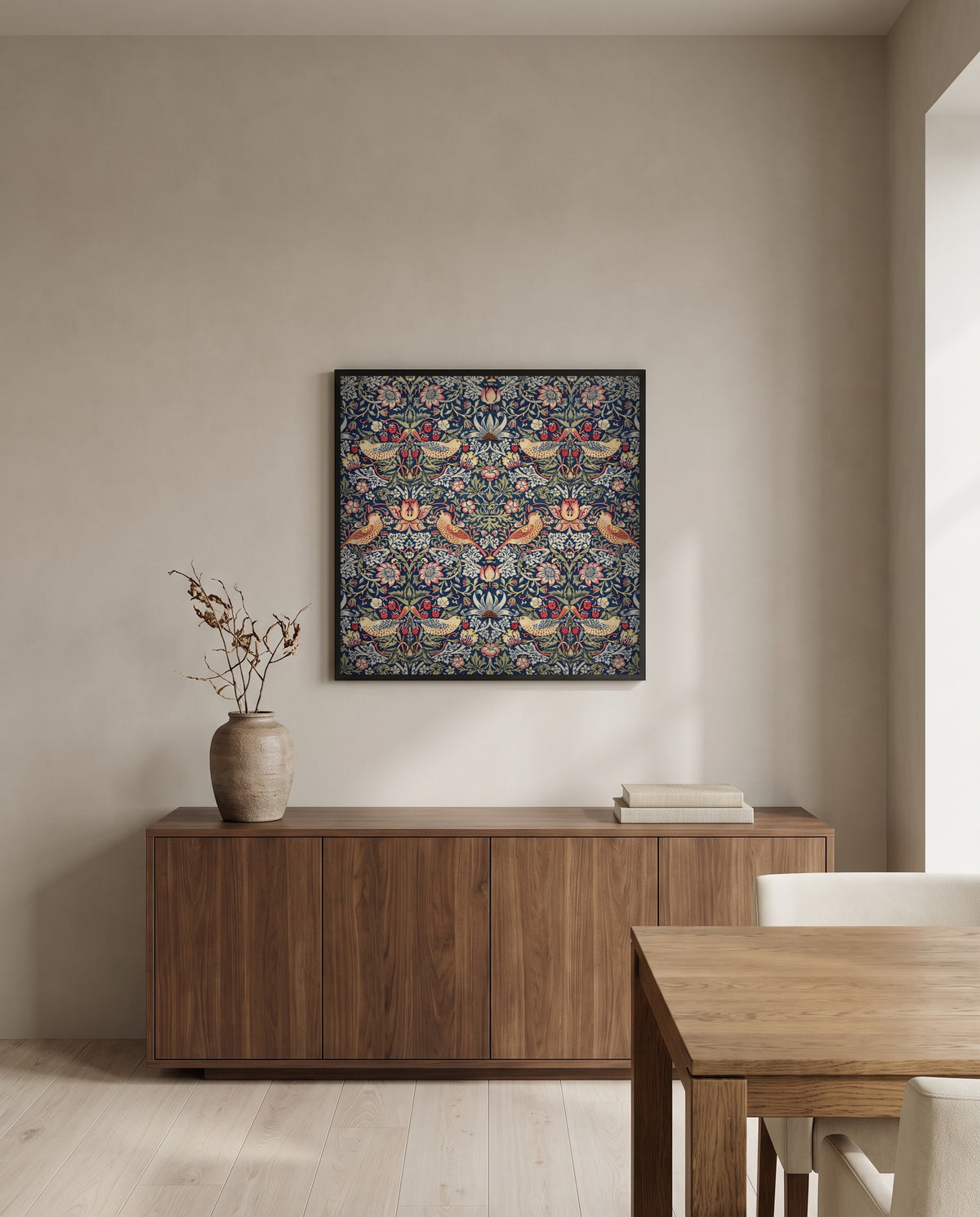 Strawberry Thief by William Morris in a black frame above a walnut sideboard in a dining room