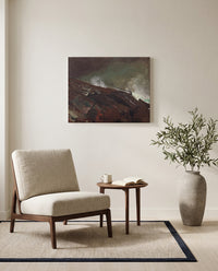 Coast of Maine by Winslow Homer as a stretched canvas above a linen lounge chair in a reading corner