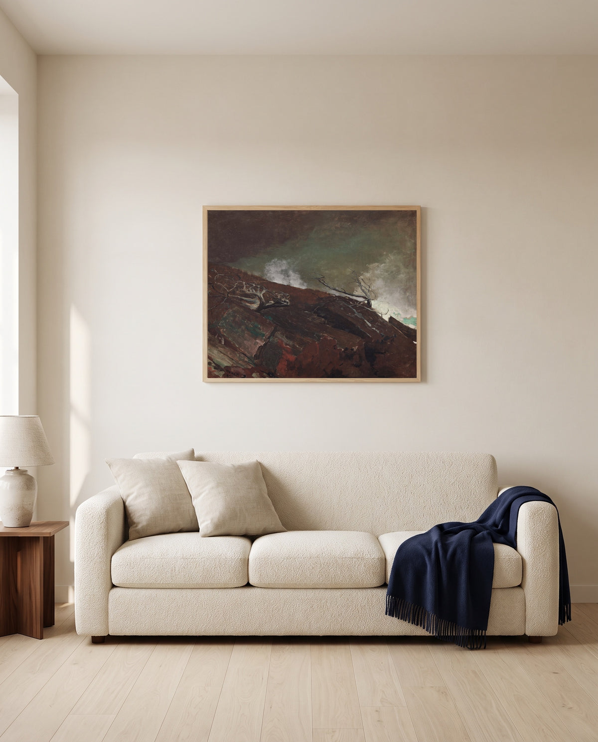 Coast of Maine by Winslow Homer framed in natural oak above a cream sofa in a warm living room