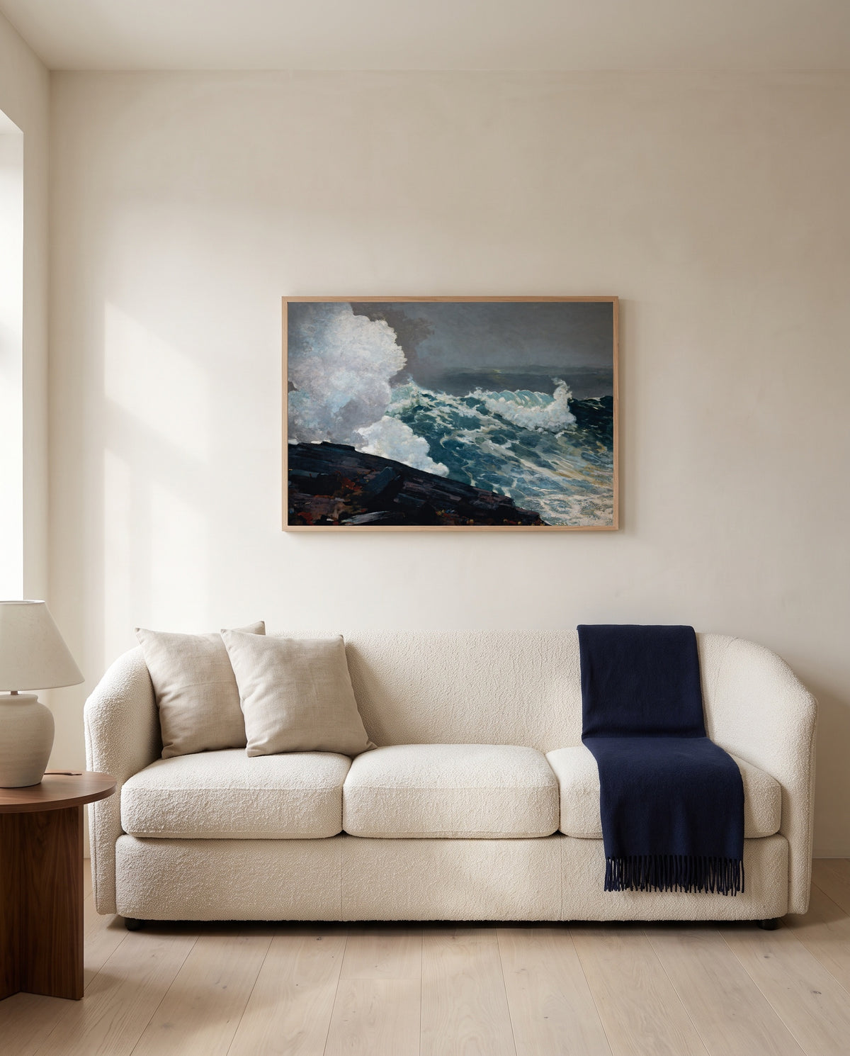 Northeaster by Winslow Homer framed in natural oak above a cream sofa in a warm living room