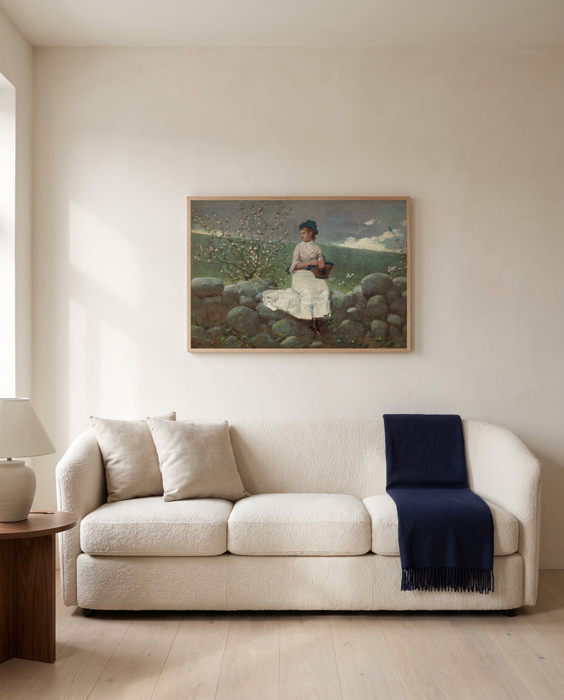 Peach Blossoms by Winslow Homer framed in natural oak above a cream sofa in a warm living room