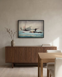 Stowing Sail by Winslow Homer in a black frame above a walnut sideboard in a dining room