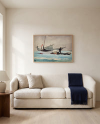 Stowing Sail by Winslow Homer framed in natural oak above a cream sofa in a warm living room