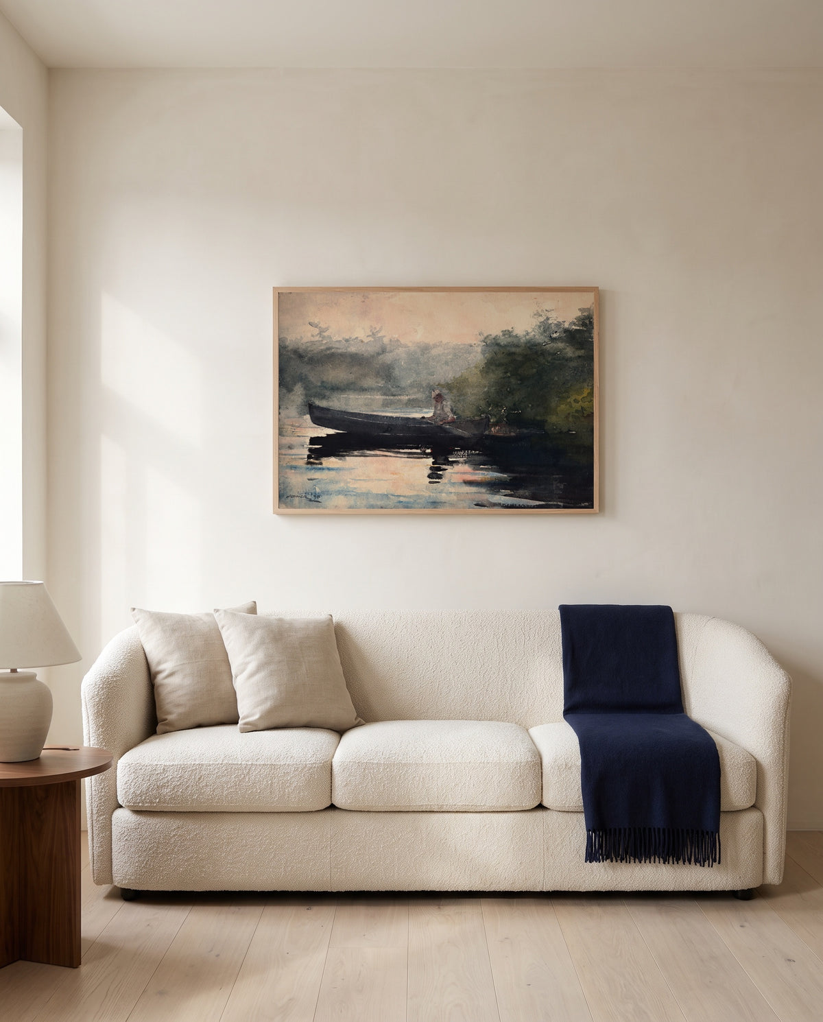 The End of the Day by Winslow Homer framed in natural oak above a cream sofa in a warm living room